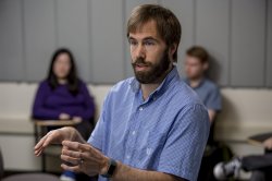 Professor Jonathan Howell in a classroom, lecturing to students.